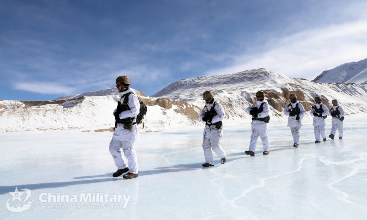 Soldiers assigned to a highland scout company with a regiment under the PLA Xinjiang Military Command patrol on frozen water during a highland tactical reconnaissance training exercise on December 30, 2021. (eng.chinamil.com.cn/Photo by Han Qiang) 