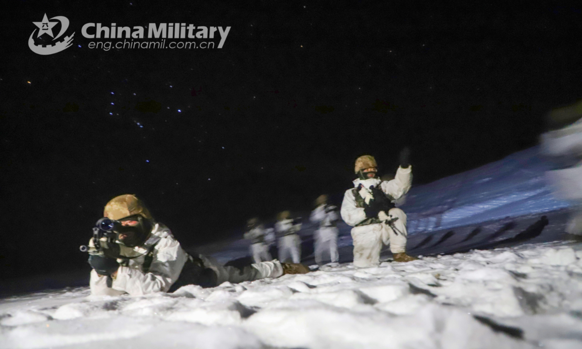 Soldiers assigned to a highland scout company with a regiment under the PLA Xinjiang Military Command provide security with each other while advancing to engage mock enemy positions in ice and snow during a highland tactical reconnaissance training exercise on December 30, 2021. (eng.chinamil.com.cn/Photo by Han Qiang)