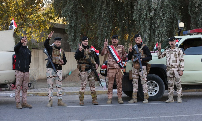 Iraqi soldiers wave the victory sign to celebrate Army Day in Baghdad, Iraq, on Jan. 6, 2022.(Photo: Xinhua)