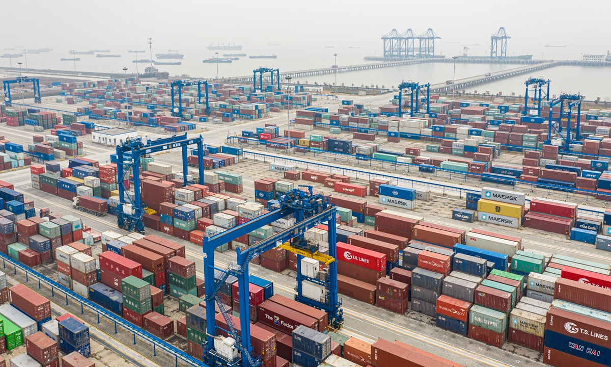 Containers are handled at the Port of Nantong in East China's Jiangsu Province on January 9, 2022. According to local transport authorities, throughput at the port reached 2.03 million standard containers in 2021, a record high. 