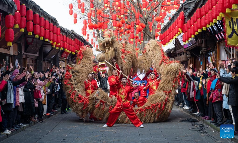 People perform folk dancing of a dragon made of grass at Langzhong ancient town in southwest China's Sichuan Province, Jan. 8, 2022.Photo:Xinhua