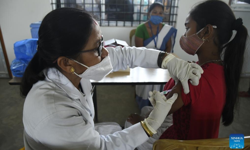 A girl receives a dose of COVID-19 vaccine at a school in Nagaon district of India's northeastern state of Assam, Jan. 8, 2022.Photo:Xinhua