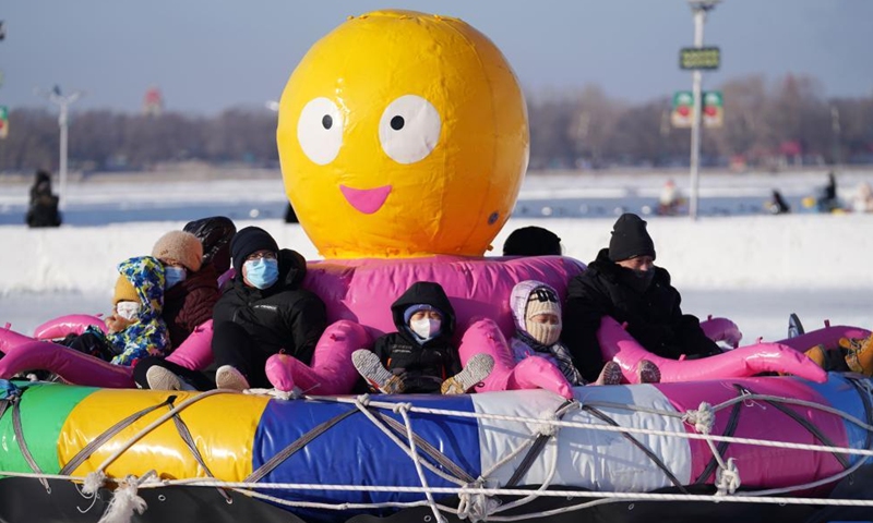 People enjoy ice-snow fun on an entertainment facility on the frozen Songhua River in Harbin, northeast China's Heilongjiang Province, Jan. 8, 2022.Photo:Xinhua