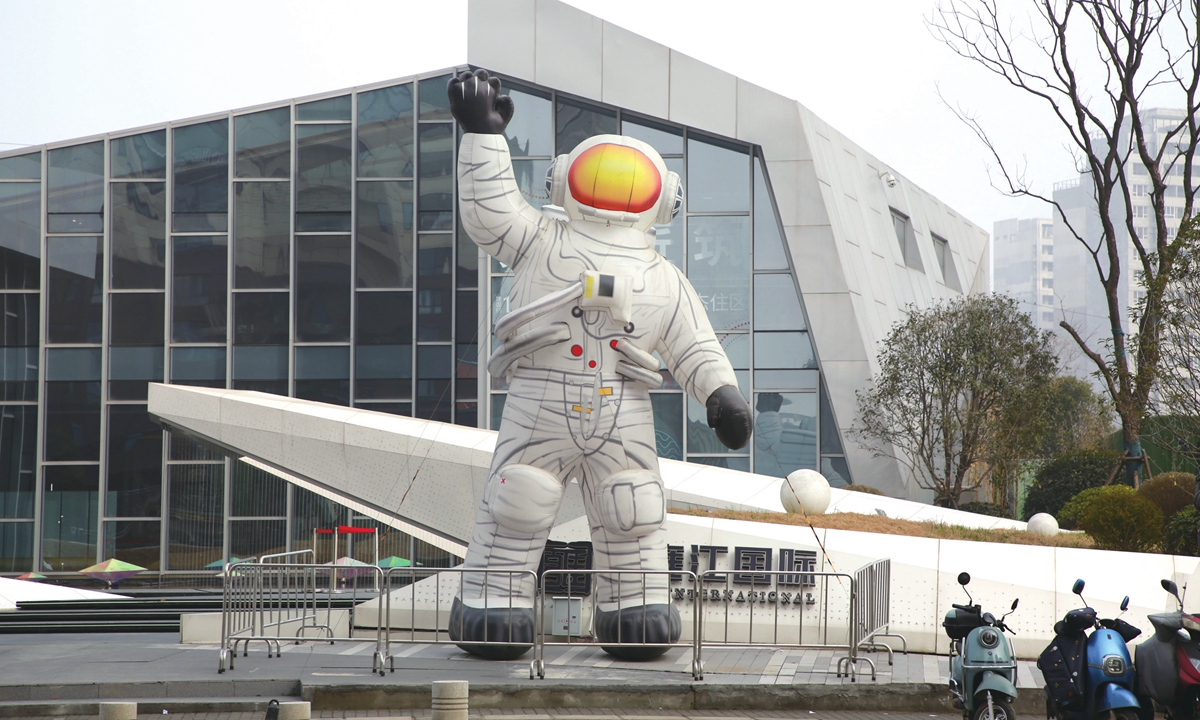 A large inflatable model of an astronaut waves on a street in Xiangyang, Central China's Hubei Province. Photo: IC