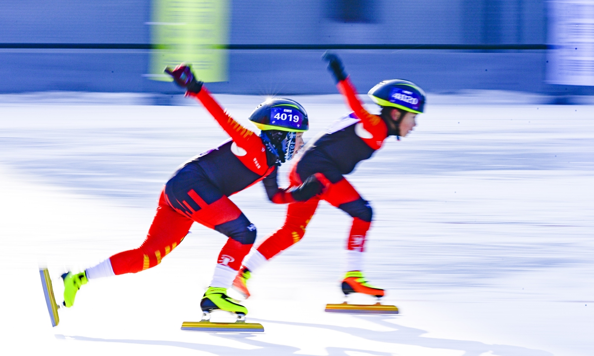 Two teenage skaters compete in a race at the 2022 Hohhot Youth Skating Championship held at a local school in Hohhot, North China's Inner Mongolia Autonomous Region on January 11, 2022. Photo: VCG
