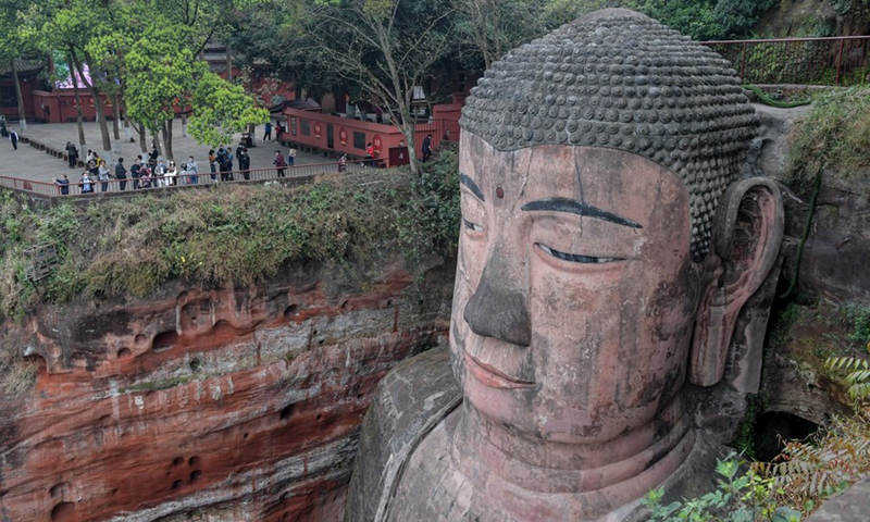 Tourists view the statue of the Leshan Giant Buddha in Leshan City, southwest China's Sichuan Province, March 23, 2020.(Photo: Xinhua)