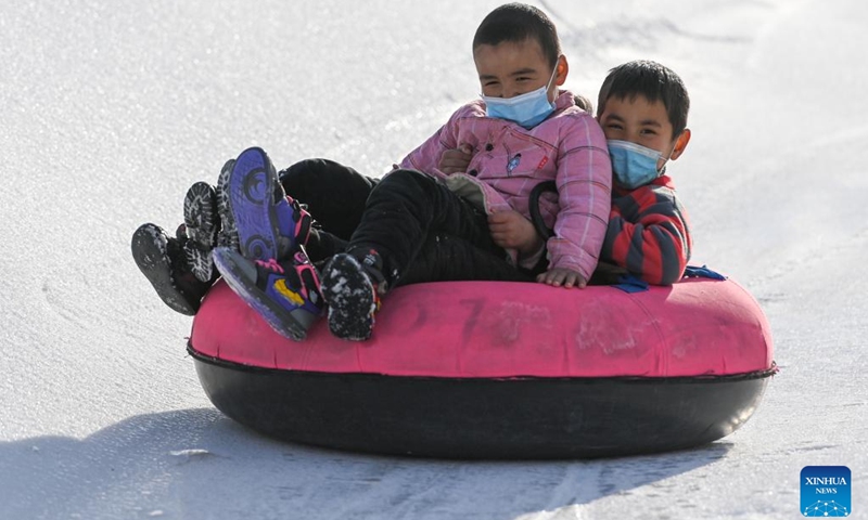 Children play on a snow tube at Oynak ski resort in Moyu County, northwest China's Xinjiang Uygur Autonomous Region, Jan. 9, 2022. Located on the southern brim of the Taklimakan Desert, Moyu County barely snows in winter. In order to boost its winter tourism and extend the tourism season, the county built Oynak ski resort by making artificial snow, fueling people's passion for winter sports here. (Photo: Xinhua)