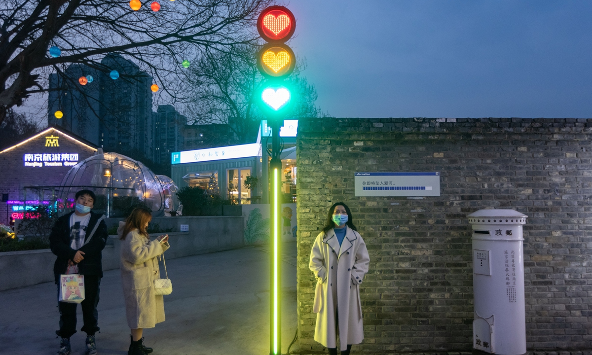 A pedestrian stands beside a 
