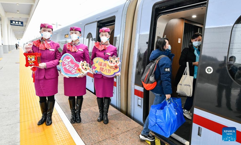 Crew members display tiger decorations beside the bullet train C5980 at the Guiyang North Railway Station in Guiyang, southwest China's Guizhou Province, Jan. 9, 2022. Crew members of the train C5980 held various activities to greet the Laba Festival.(Photo: Xinhua)