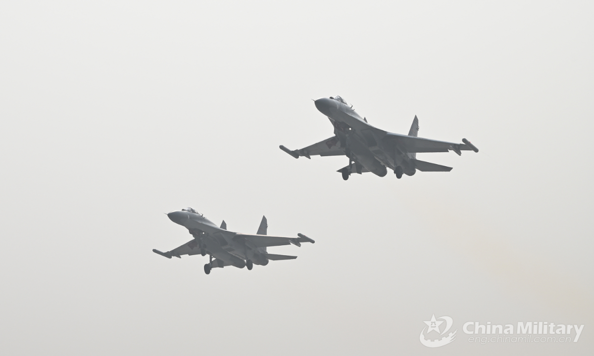 Two fighter jets attached to an aviation brigade of the air force under the PLA Western Theater Command take off to the target air space in two-plane formation during a live-fire air battle training exercise on January 7, 2022, which aims to beef up the pilots' air combat capability. (eng.chinamil.com.cn/Photo by Zhao Tian)