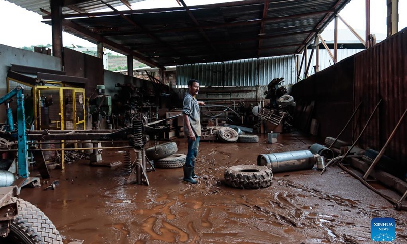 A man shows a workshop after a flood caused by heavy rains in Sabara, Minas Gerais state, Brazil, on Jan. 11, 2022. At least 10 people were killed in the past 24 hours after heavy rains in the southeastern Brazilian state of Minas Gerais, and more than 13,000 people were forced to leave their homes, the regional civil defense authorities said Tuesday.(Photo: Xinhua)