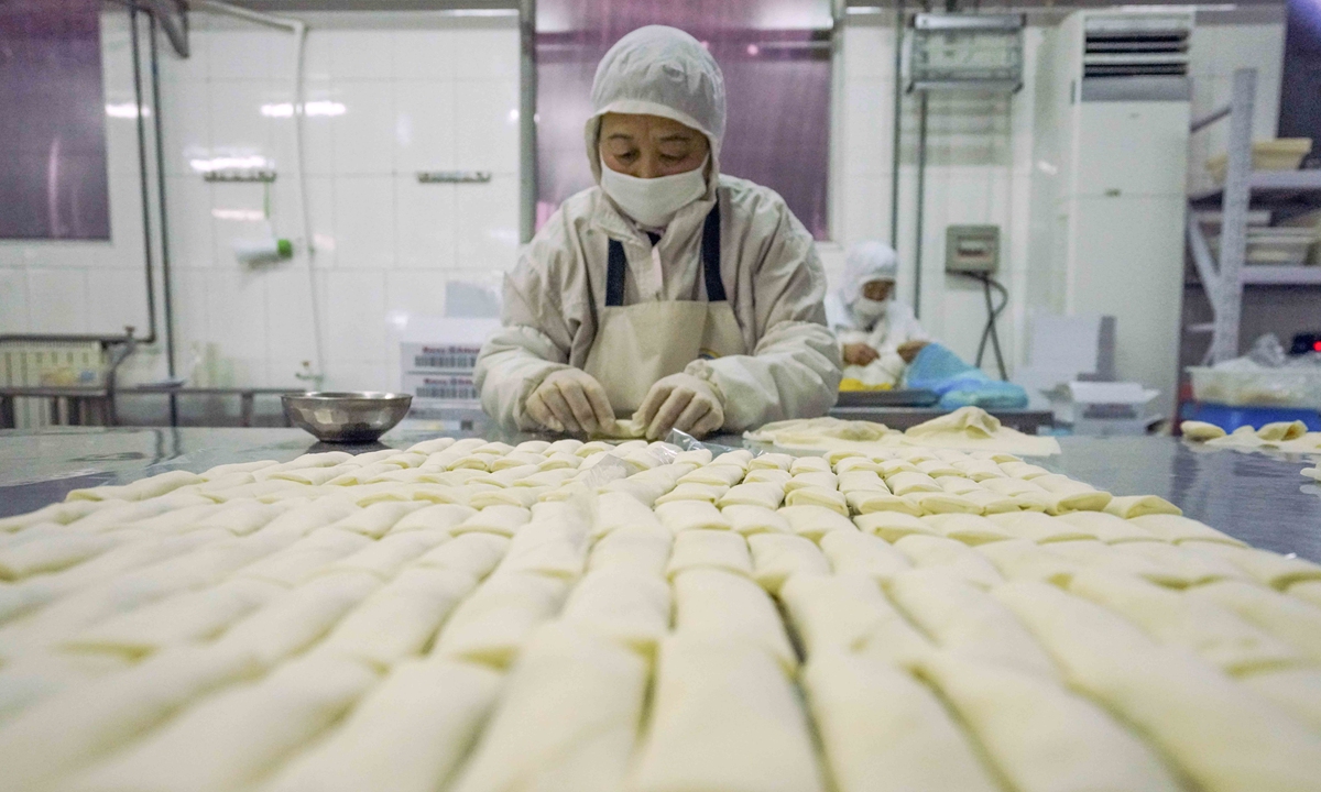 A worker makes Spring Rolls, or Chun Juan in Chinese, at a food processing factory in Zunhua, North China's Hebei Province on January 13, 2022 to satisfy festival demand as the Chinese New Year approaches. Photo: cnsphoto