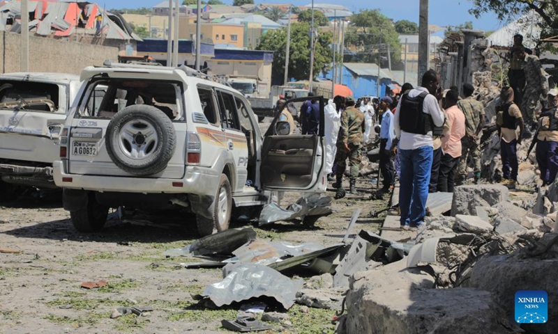 People gather at the scene of a suicide car bombing attack in Mogadishu, Somalia, on Jan. 12, 2022. At least ten people including five soldiers were killed and nine others wounded in a suicide car bombing in the Somali capital, Mogadishu on Wednesday, officials said.(Photo: Xinhua)