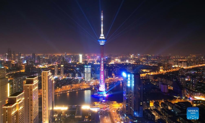 Aerial photo shows a landmark lit up to pay tribute to people making efforts to fight against the recent resurgence of COVID-19 pandemic in north China's Tianjin, Jan. 13, 2022.Photo:Xinhua
