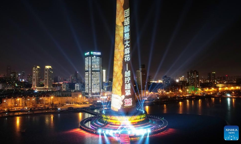 Aerial photo shows a landmark lit up to pay tribute to people making efforts to fight against the recent resurgence of COVID-19 pandemic in north China's Tianjin, Jan. 13, 2022.Photo:Xinhua