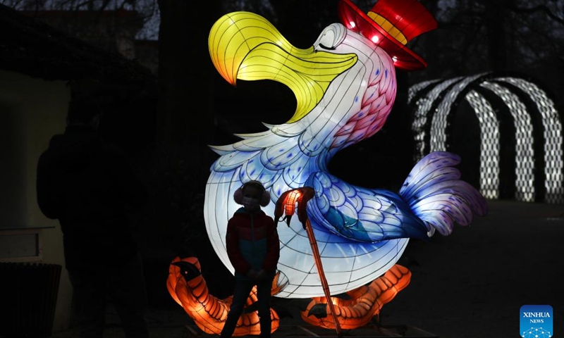 A visitor views light installations during the sixth edition of China light festival themed Alice in Wonderland at the Antwerp Zoo in Antwerp, Belgium, Jan. 12, 2022.(Photo: Xinhua)