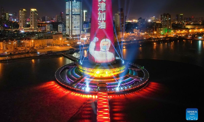 Aerial photo shows a landmark lit up to pay tribute to people making efforts to fight against the recent resurgence of COVID-19 pandemic in north China's Tianjin, Jan. 13, 2022.Photo:Xinhua