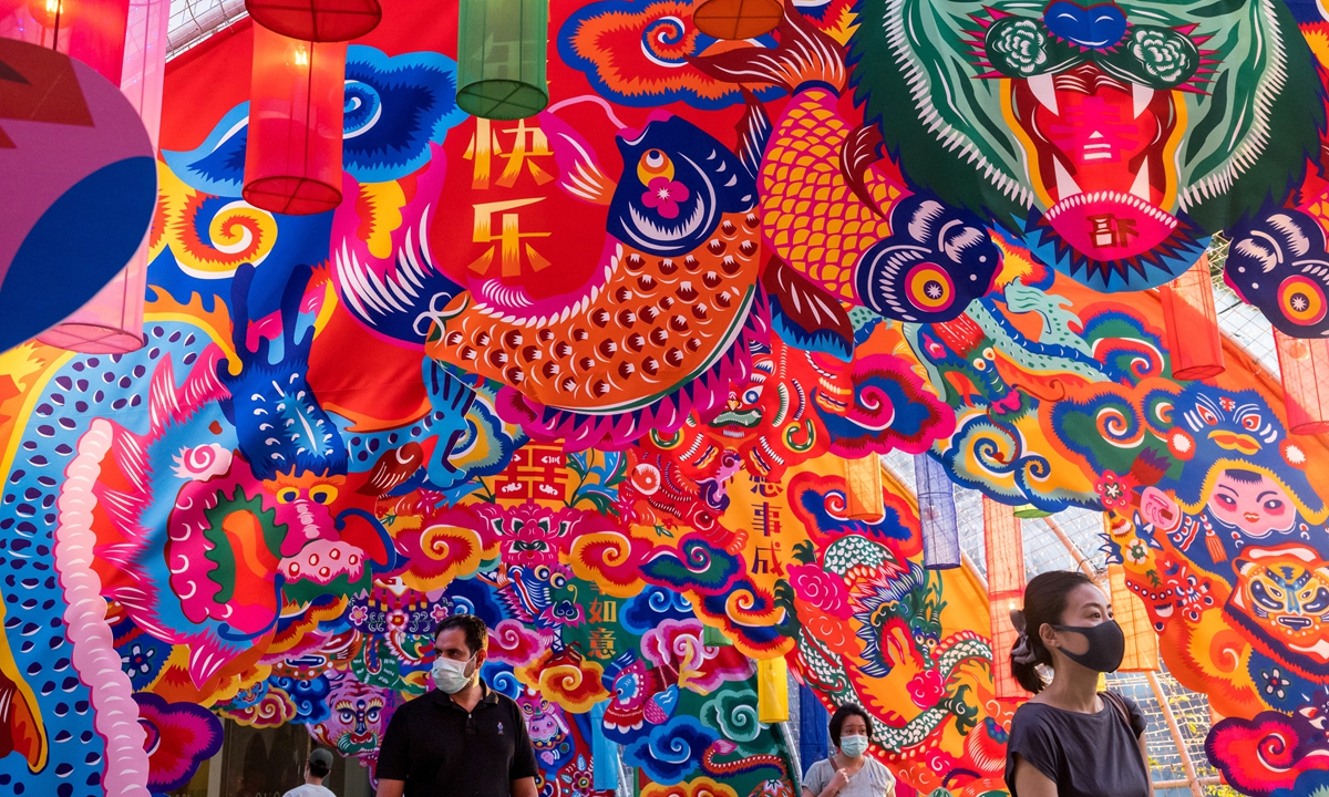 People walk below a tiger-themed display outside a shopping mall ahead of the Lunar New Year in Bangkok, Thailand on January 14, 2022. Photo: AFP