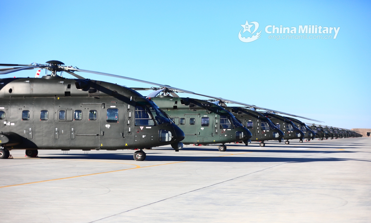 A cluster of Z-8 transport helicopters attached to an army aviation brigade under the PLA 76th Group Army sit abreast on the flightline prior to a flight training exercise on January 5, 2022.Photo:China Military
