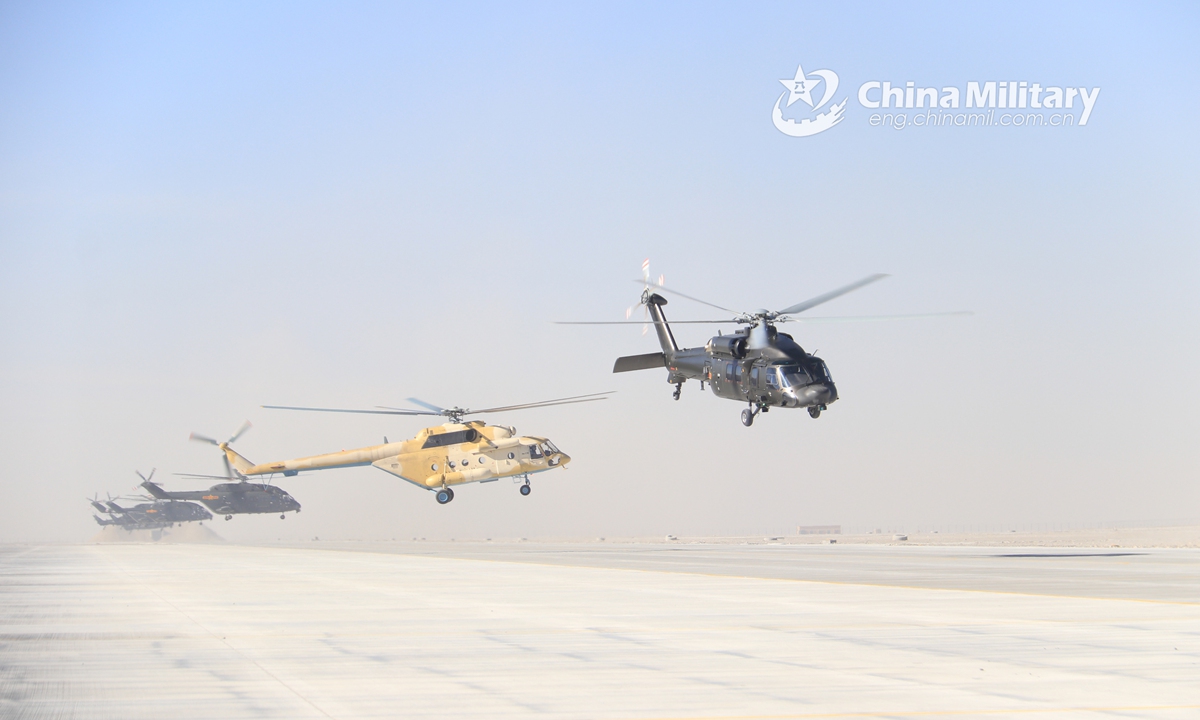Multiple types of transport and attack helicopters attached to an army aviation brigade under the PLA 76th Group Army lift off successively for a flight training exercise on January 5, 2022.Photo:China Military