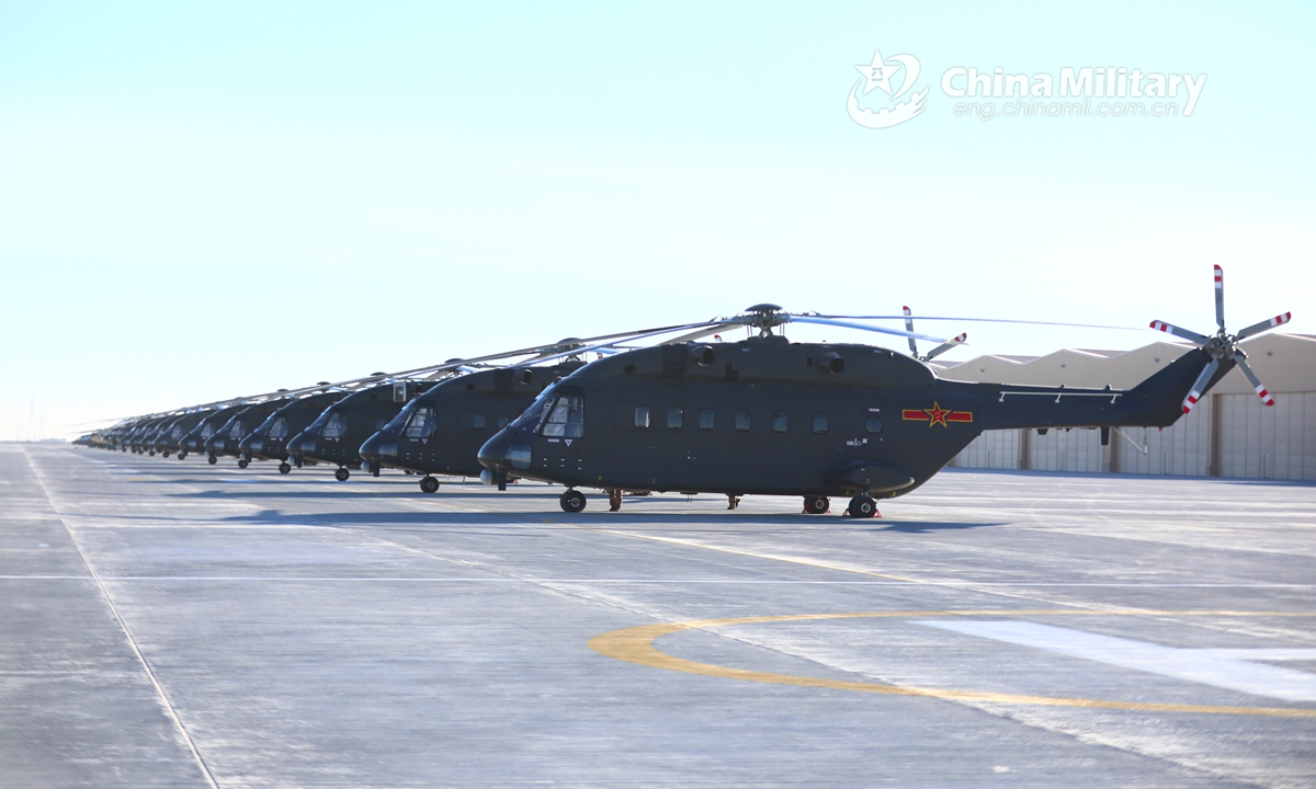 A cluster of Z-8 transport helicopters attached to an army aviation brigade under the PLA 76th Group Army sit abreast on the flightline prior to a flight training exercise on January 5, 2022.Photo:China Military