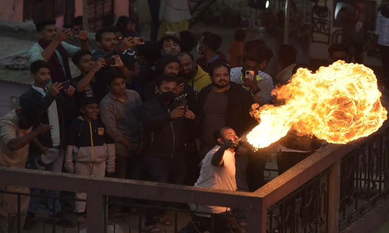 A man performs fire breathing during Sakrain festival in Dhaka, capital of Bangladesh, on Jan. 14, 2022.Photo:Xinhua