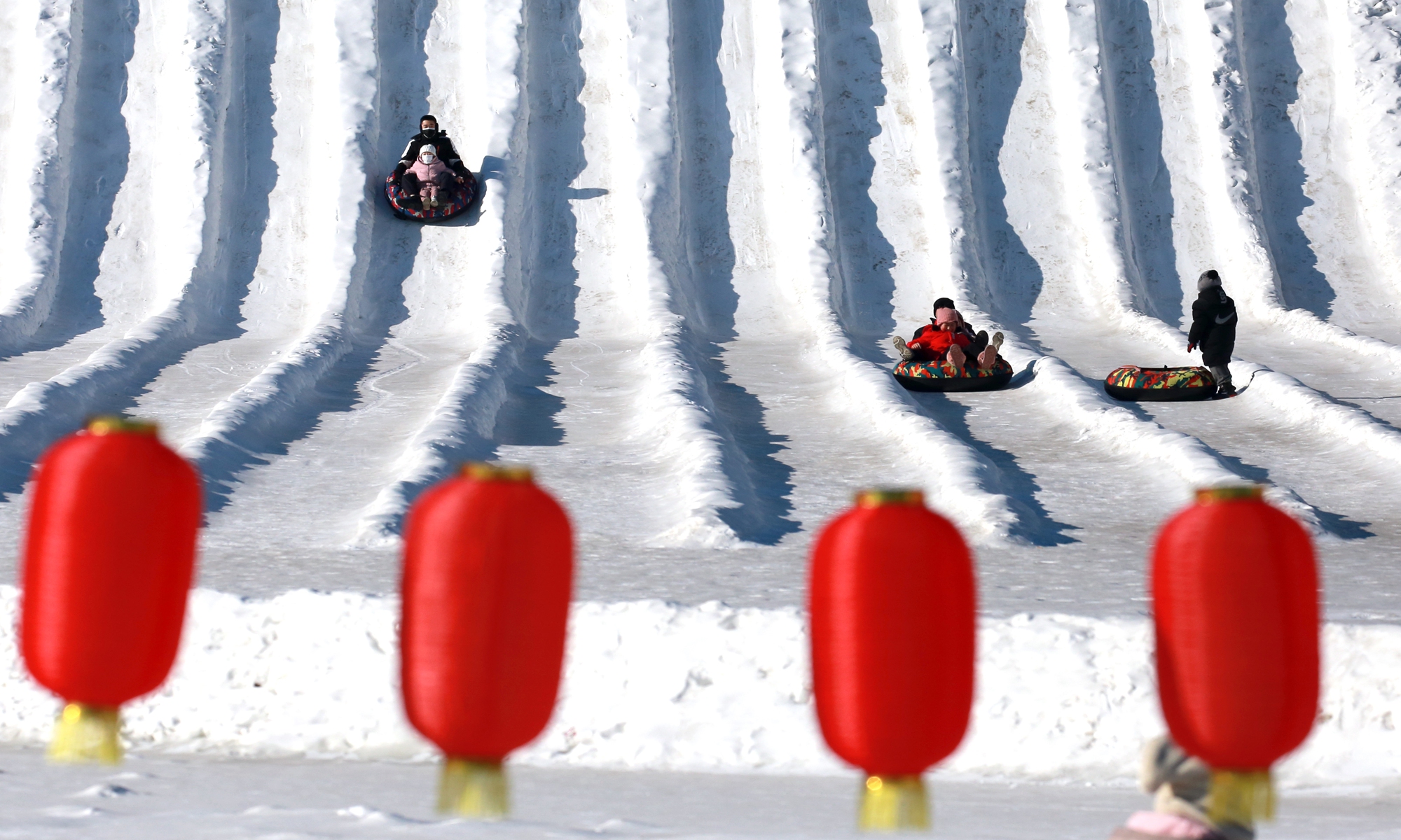 Parents take their children for a winter break at the Beiling Park Ice and Snow World in Shenyang, Northeast China's Liaoning Province, on January 16, 2022. Photo: IC