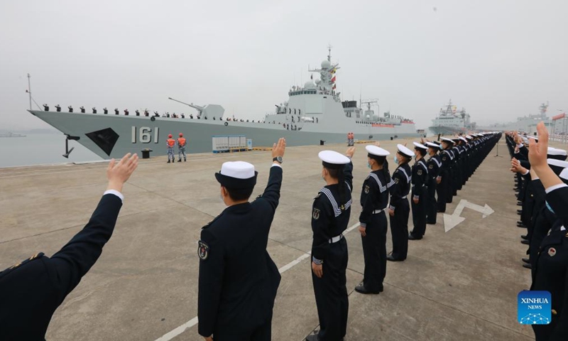 Soldiers wave goodbye to the fleet of the Chinese People's Liberation Army (PLA) Navy at a military port in Zhanjiang City, south China's Guangdong Province, Jan. 15, 2022.Photo:Xinhua