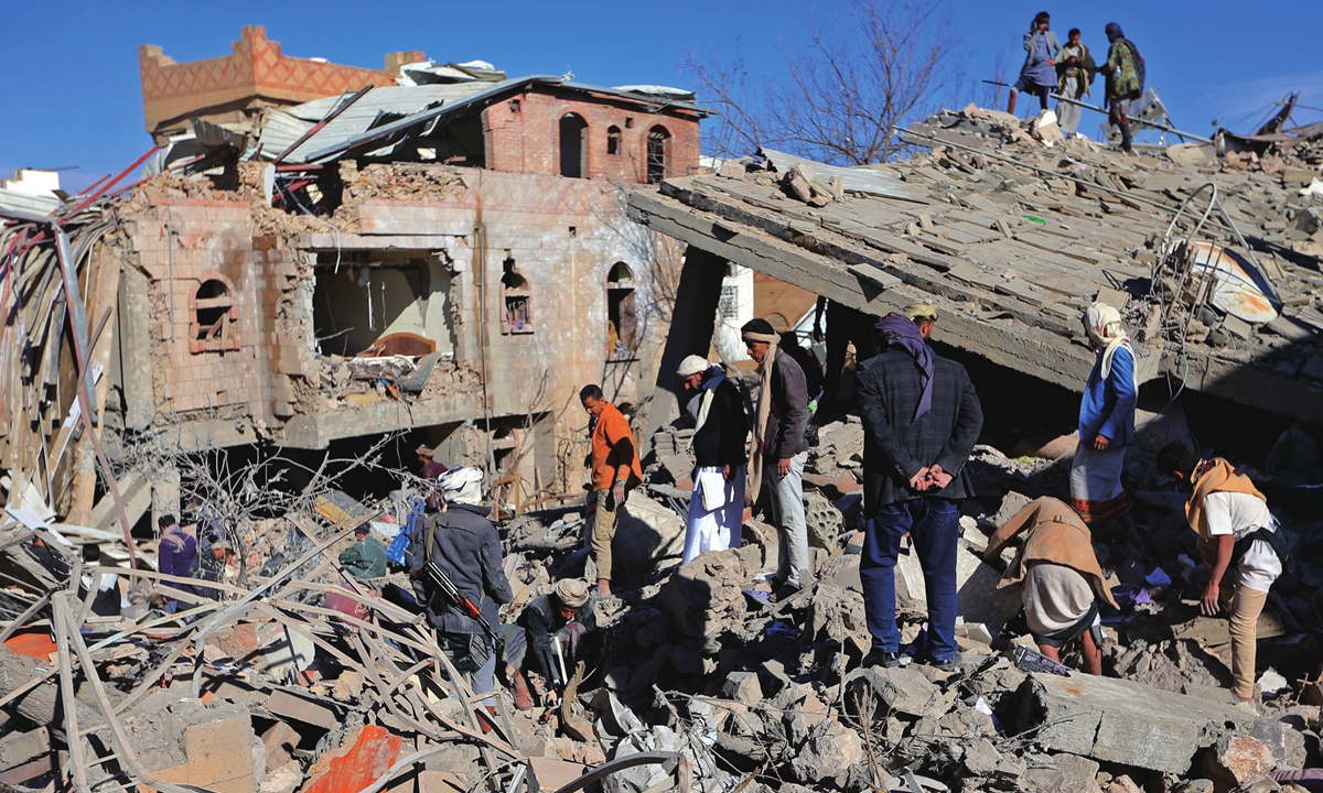 Yemenis inspect the damage following overnight air strikes by the Saudi-led coalition targeting the Houthi rebel-held capital Sanaa, on January 18, 2022. The Saudi-led coalition fighting Yemen's Houthi insurgents said it had launched air strikes targeting the rebel-held capital Sanaa after a deadly attack against coalition ally Abu Dhabi. Photo: AFP