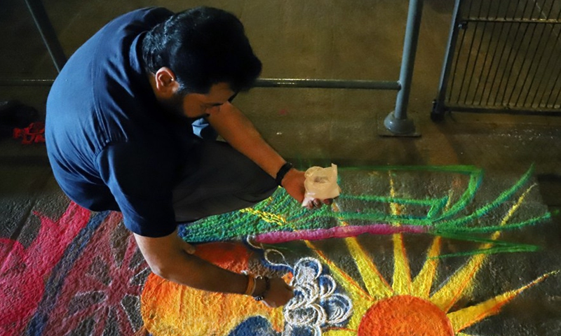 A man makes a colorful design during the festival of Thai Pongal in Colombo, Sri Lanka, on Jan. 14, 2022.Photo:Xinhua