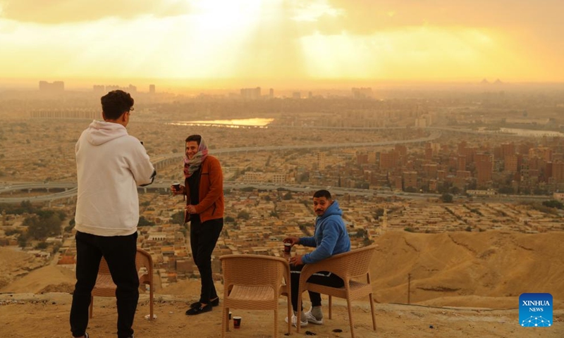 People enjoy the sunset view on Mokattam mountain in Cairo, Egypt, on Jan. 16, 2022.Photo:Xinhua