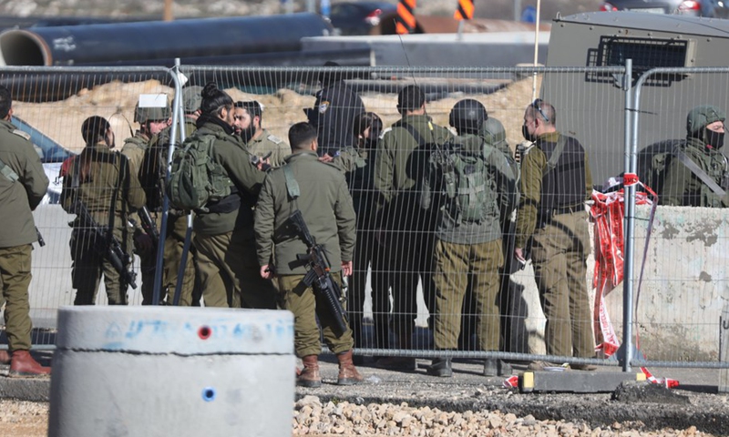 Israeli soldiers are seen at the scene where a knife-wielding Palestinian man was shot dead at the Gush Etzion Junction north of the West Bank city of Hebron, on Jan. 17, 2022.(Photo: Xinhua)