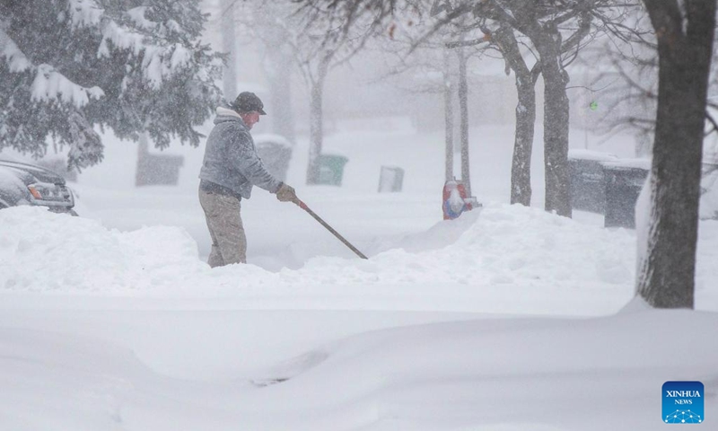 A man clears his driveway during a snowy day in Mississauga, the Greater Toronto Area, Canada, on Jan. 17, 2022. Environment Canada issued a winter storm warning calling for up to 60 cm of snow in some parts of the Greater Toronto Area by Monday night.(Photo: Xinhua)