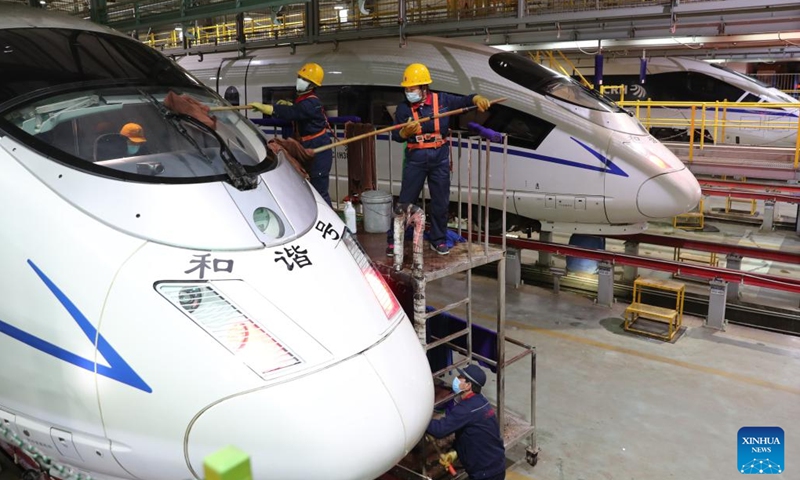 Staff members clean a bullet train at a maintenance base of Lanzhou West bullet train service station in Lanzhou, northwest China's Gansu Province, Jan. 16, 2022. Staff members from Lanzhou West bullet train service station of Lanzhou section of China Railway Lanzhou Group Co., Ltd. carried out maintenance work for trains to prepare for the country's annual Spring Festival travel rush.(Photo: Xinhua)