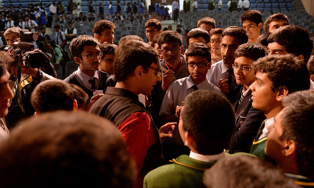 A mathematics professor at Princeton University, interacts with students of Bishop Cottons Boys School on the wonders and values of mathematics in Bangalore on January 21, 2015. Photo: AFP 