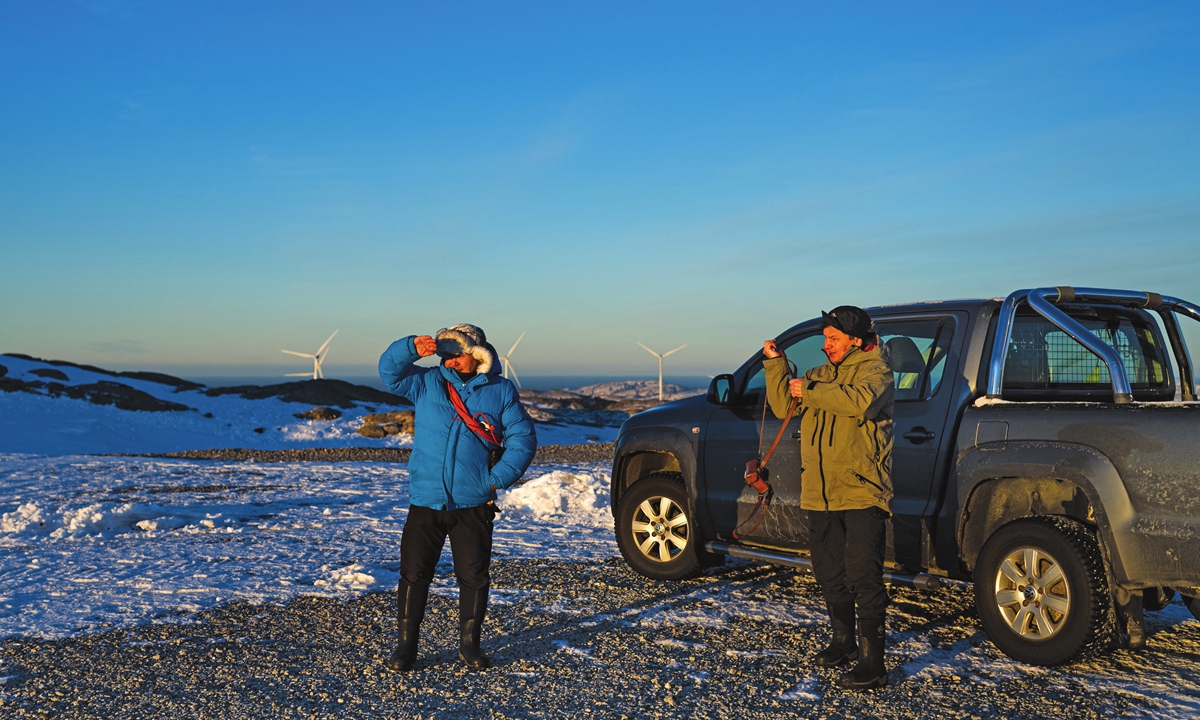 Reindeer herders, Leif Arne Jama (right) and his brother John Kristian Jama, visit the Storheia wind farm, one of Europe's largest land-based wind parks, in Norway on December 7, 2021. Photo:AFP