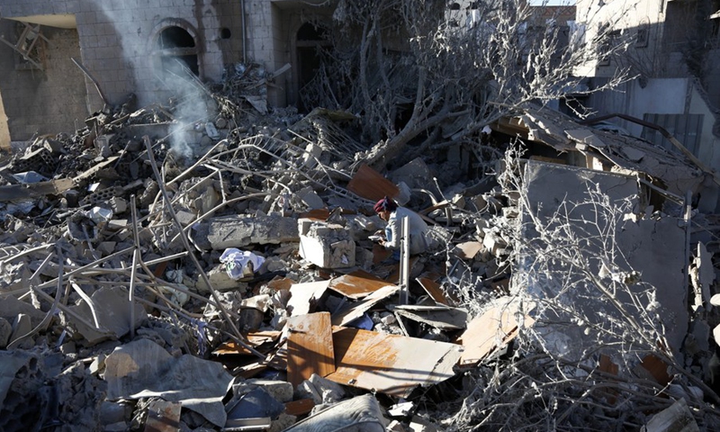 A man searches for his belongings among the rubble of a house destroyed by airstrikes in Sanaa, Yemen, on Jan. 18, 2022.(Photo: Xinhua)