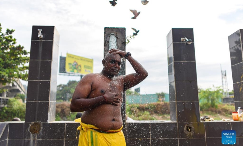 A Hindu devotee cleans himself to celebrate the Thaipusam festival with at Batu Caves on the outskirts of Kuala Lumpur, Malaysia, Jan. 18, 2022.(Photo: Xinhua)