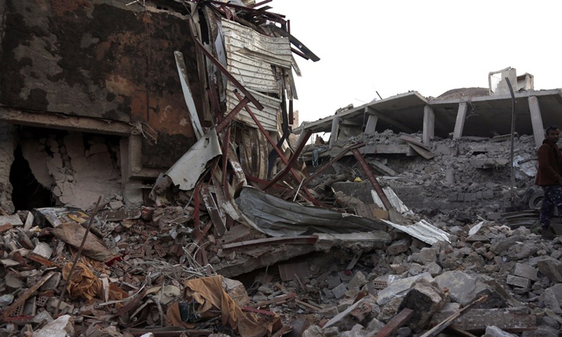 A man stands on the rubble of a house destroyed by airstrikes in Sanaa, Yemen, on Jan. 18, 2022.(Photo: Xinhua)