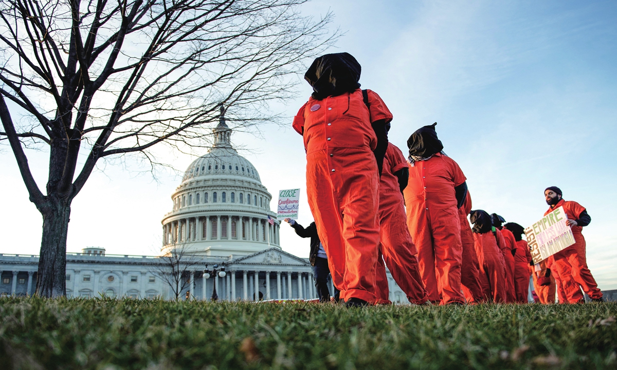 Demonstrators dressed in Guantanamo Bay prisoner uniforms march past Capitol Hill in Washington, DC, on January 9, 2020, during a rally on No War with Iran.
Brendan Smialowski / AFP
