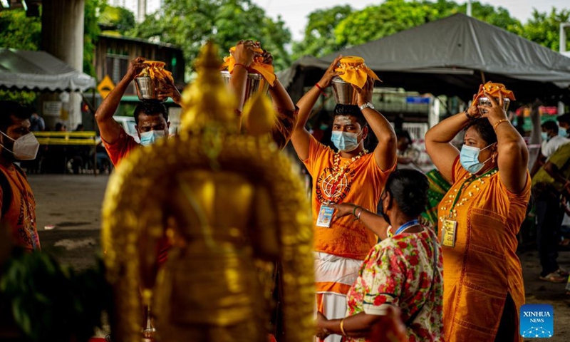 Hindu devotees carry milk pots in a procession to Sri Subramaniar Swamy Temple to celebrate the Thaipusam festival at Batu Caves on the outskirts of Kuala Lumpur, Malaysia, Jan. 18, 2022. (Photo: Xinhua)