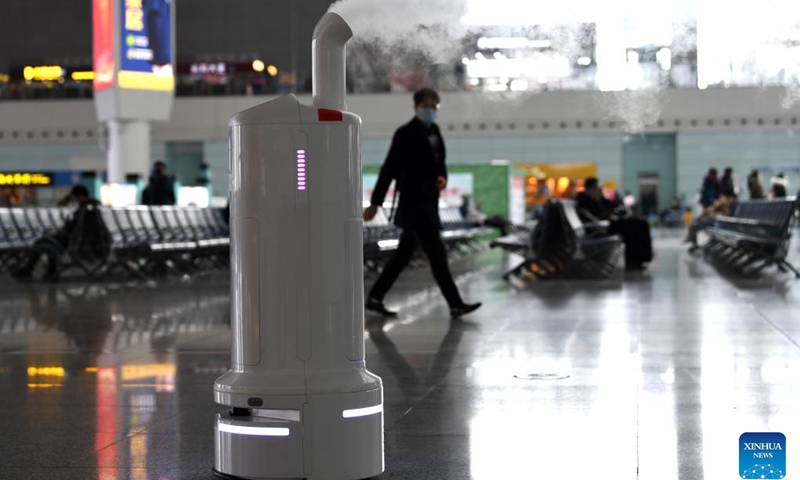 Air environment automatic sterilizer robot Xiao Chuang sprays disinfectant at Hefei South Railway Station in Hefei, east China's Anhui Province, Jan. 18, 2022. Air environment automatic sterilizer robot Xiao Chuang, intelligent temperature measuring robot Da Bai and ground cleaning and disinfecting robot Xiao De have been in service for COVID-19 prevention and control during the annual Spring Festival travel rush in Hefei.(Photo: Xinhua)