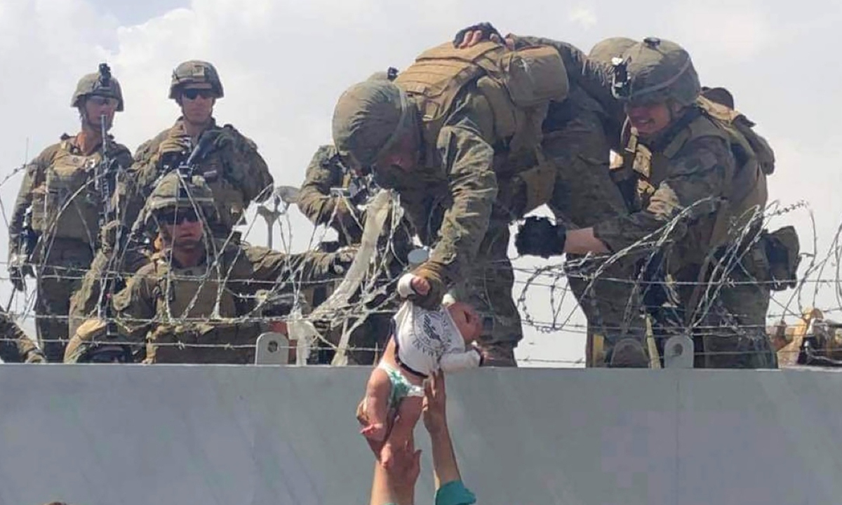 Local resident Ibrahim shows a photo of his house destroyed by a missile fired by US forces in Salahuddin province, Iraq, on January 4, 2022. Photo: Xinhua