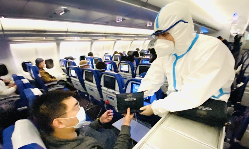 China Southern staff distribute limited edition pandemic prevention kits to passengers on some international flights to China. Photo: Courtesy of China Southern