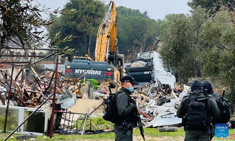 Members of the Israeli border police stand guard near a demolished house in the Sheikh Jarrah neighbourhood in East Jerusalem, Jan. 19, 2022.(Photo: Xinhua)