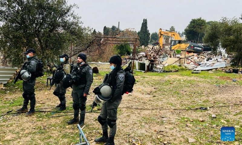 Members of the Israeli border police stand guard near a demolished house in the Sheikh Jarrah neighbourhood in East Jerusalem, Jan. 19, 2022.(Photo: Xinhua)