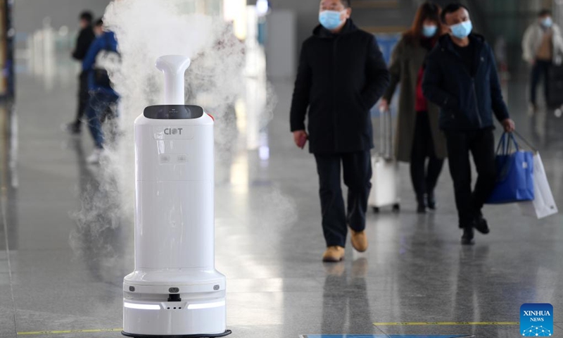 Air environment automatic sterilizer robot Xiao Chuang sprays disinfectant at Hefei South Railway Station in Hefei, east China's Anhui Province, Jan. 18, 2022. Air environment automatic sterilizer robot Xiao Chuang, intelligent temperature measuring robot Da Bai and ground cleaning and disinfecting robot Xiao De have been in service for COVID-19 prevention and control during the annual Spring Festival travel rush in Hefei.(Photo: Xinhua)