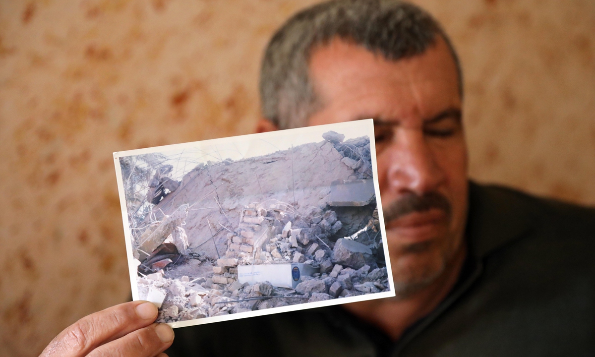 Local resident Ibrahim shows a photo of his house destroyed by a missile fired by US forces in Salahuddin province, Iraq, on January 4, 2022. Photo: Xinhua