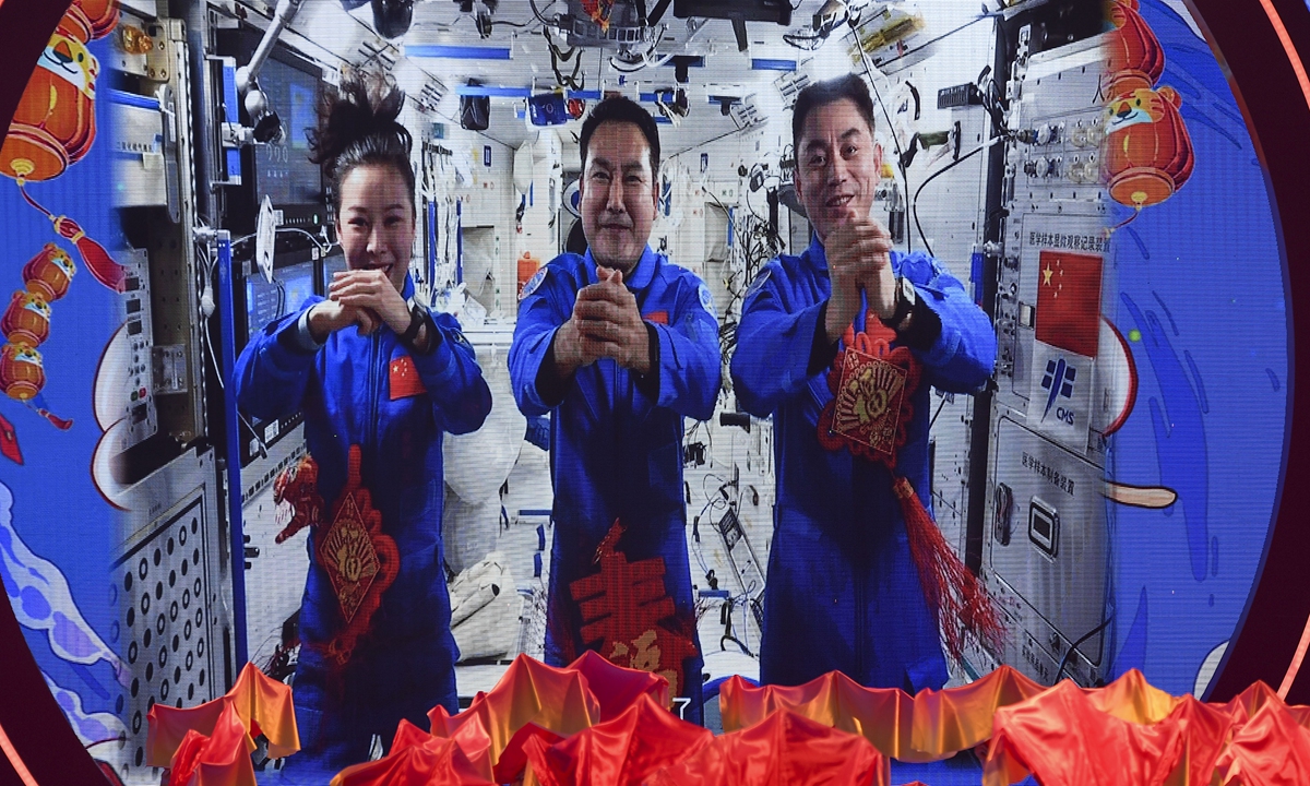 Shenzhou-13 taikonauts Zhai Zhigang, Wang Yaping and Ye Guangfu - who are living and working in the country's Tianhe space station core module - send blessings via video to all Chinese people around the world at a Chinese Lunar New Year gala held on January 22, 2022. Photo: cnsphoto