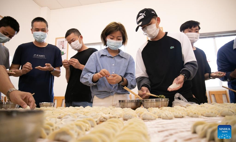 Staff members of the China-Laos Railway Luang Prabang Operation Management Center make dumplings at the center in Luang Prabang, Laos, Jan. 22, 2022.Photo:Xinhua